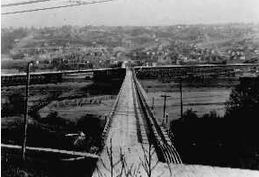 This 1929 photo shows the 23rd Avenue West Trestle from the left (north) and the Garfield Street Trestle from the right (east) meeting at mid-point. This route to Magnolia was about to end when the concrete Garfield Street Bridge replaced the wooden trestle during the next seven months. Seattle Municipal Archives #29360. 